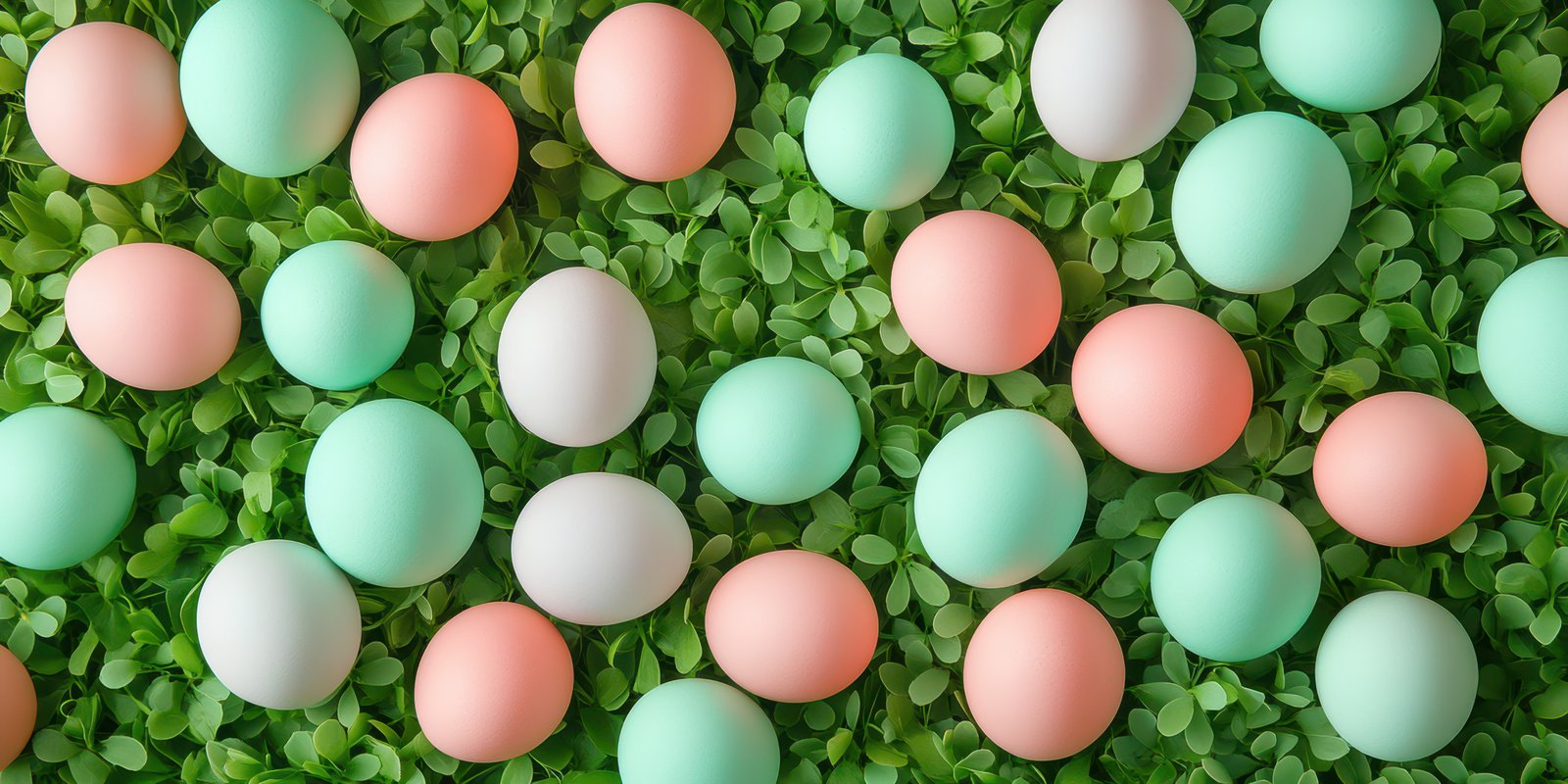 Colorful pastel eggs scattered among green foliage for a spring celebration